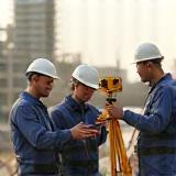 Civil engineering team surveying urban development site