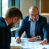 Structural consultant reviewing plans with a client